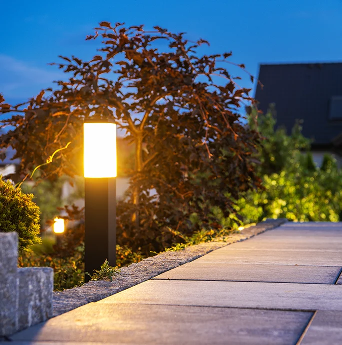 Garden lights set into small contemporary designed bollards, lighting up a garden path.