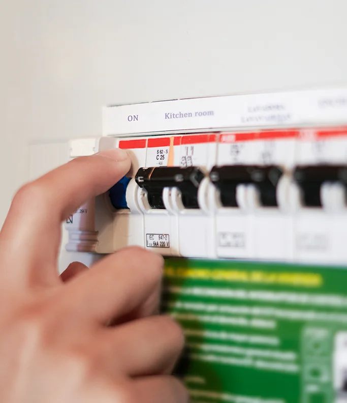 Close up of a flicking a switch on a consumer unit.