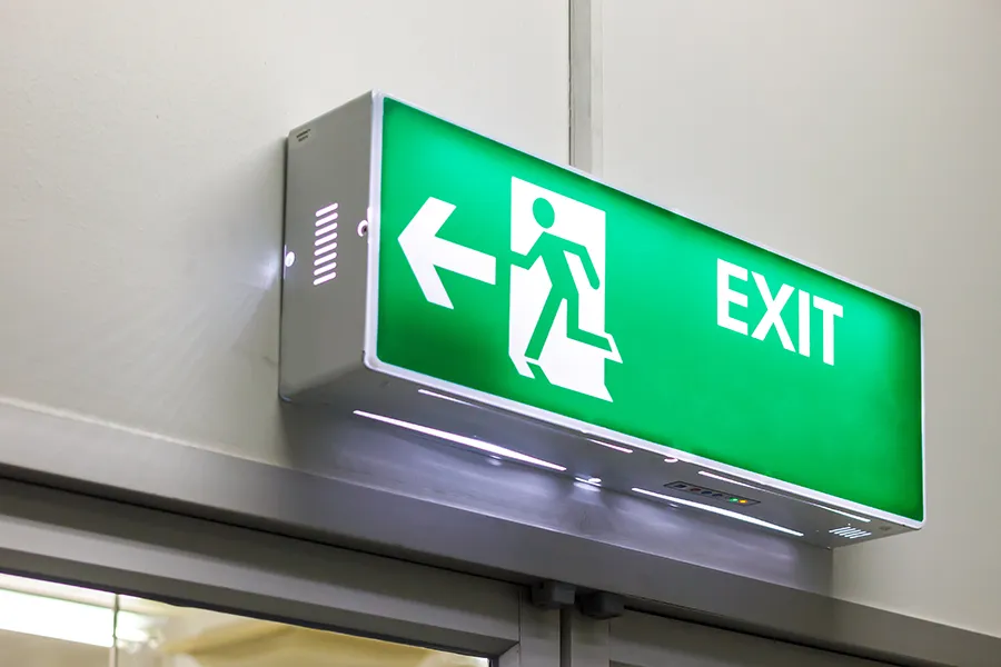 A close up of a fire exit light sign.