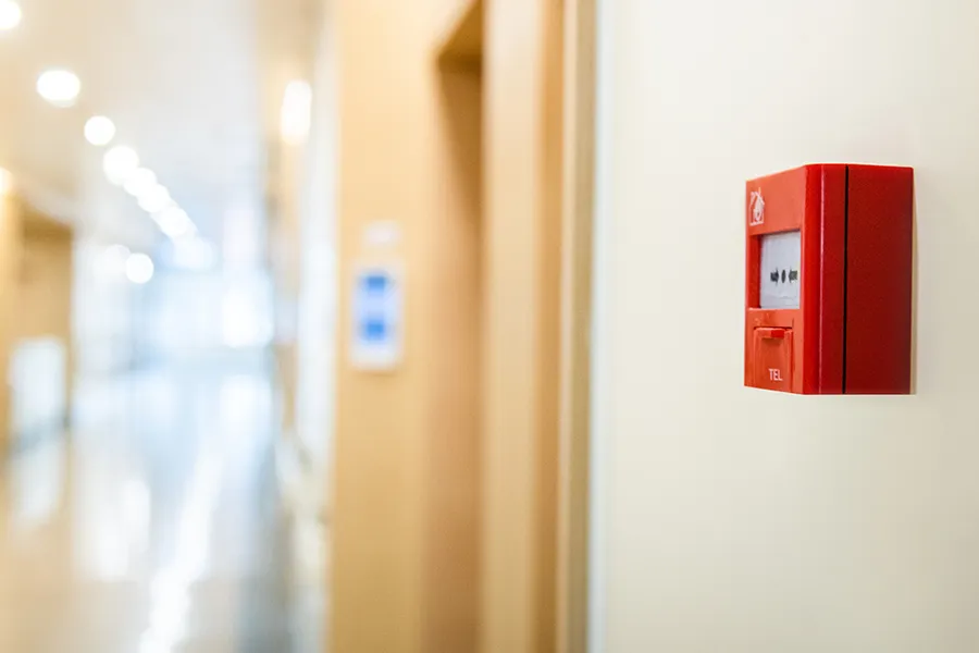 Fire Alarm System Design Fire alarm system box on the wall in the corridor of a commercial premises.