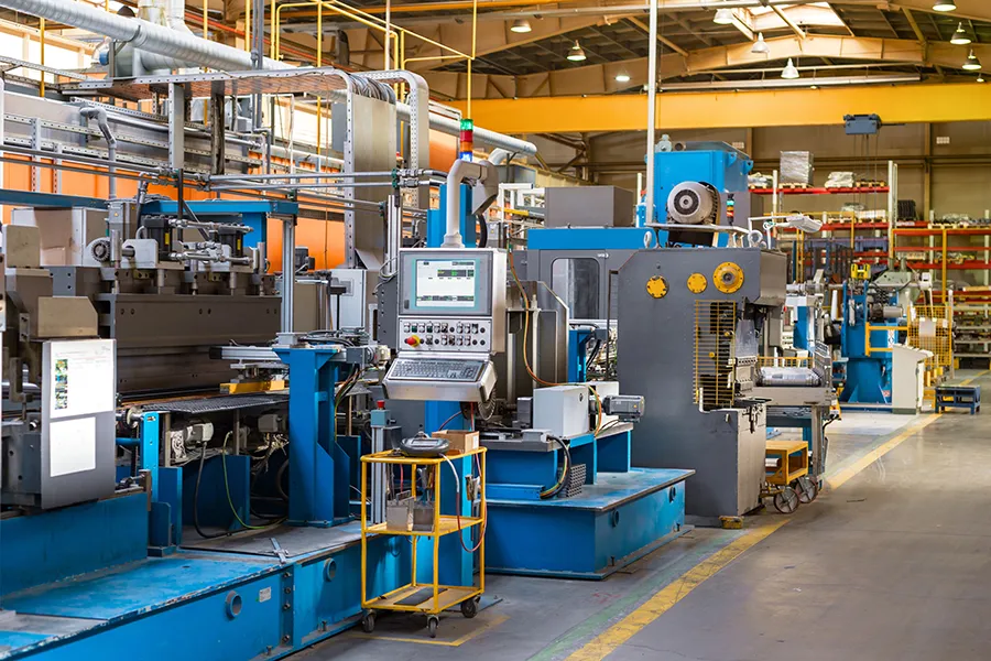 The interior of a large metalworking shop with a large specialist machinery installation that runs on a three-phase power supply.