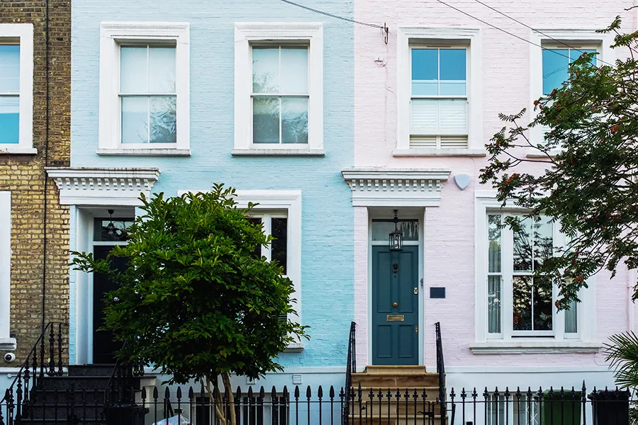 Narrow Georgian terraced housing in pastel colours highlighting the importance of electrical safety in rental properties.