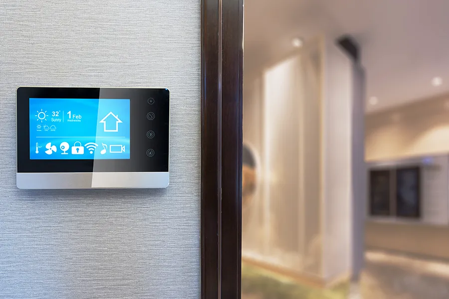 A smart device on a wall to control appliances in a property.